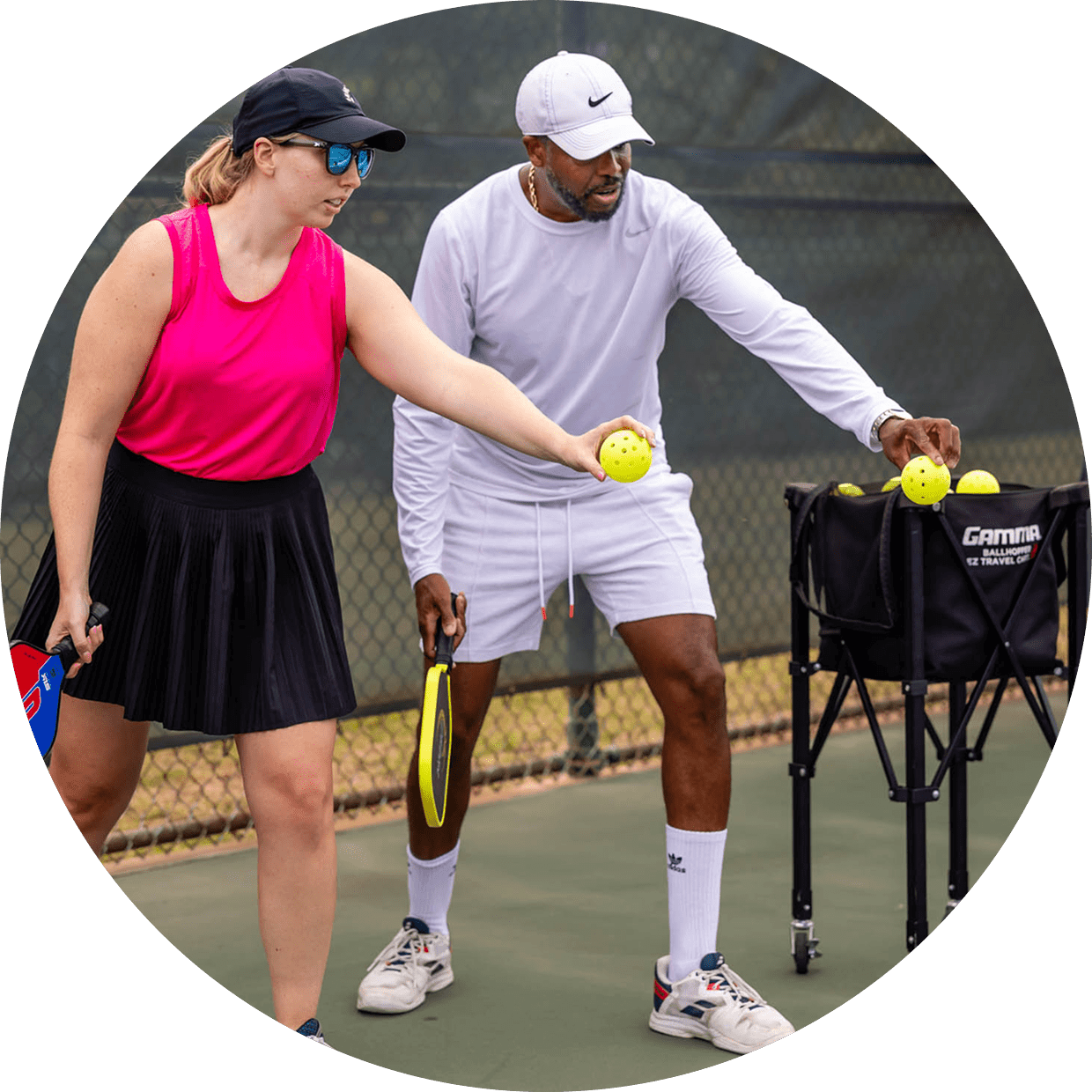 Two people preparing to play tennis on a court.